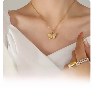 Detail of 18k gold plated titanium butterfly necklace with sparkling cubic zirconia