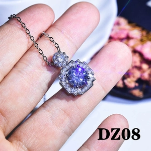 Macro shot of silver necklace featuring a square blue pendant with halo diamond setting