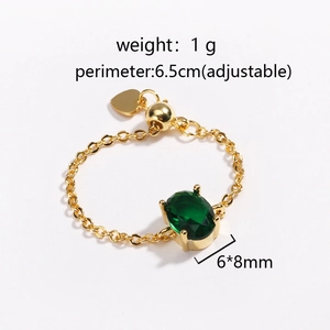 Detail view of adjustable gold chain ring featuring a 6x8mm green oval zircon stone