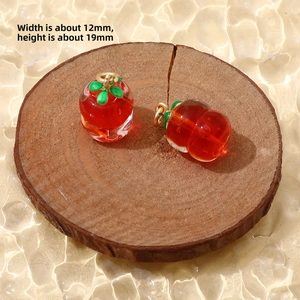 Macro shot of a red glass apple pendant with dimensions 12mm wide and 19mm high