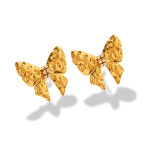 Detailed close-up of golden bow-shaped stud earrings with sparkling zircon center stone