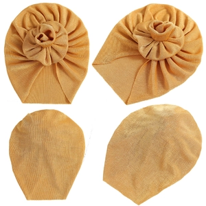 Golden infant turban hat with 3D flower design made of pleated elastic fabric