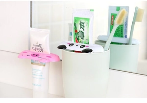 Detail of cartoon animal tube squeezers showing clips on toothpaste and facial cleanser
