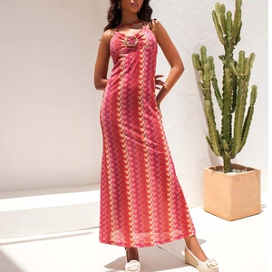 Pink and orange striped halter maxi dress with a circular buckle for beach vacations