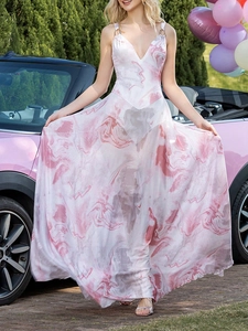 Robe longue à col en V, imprimé marbre rose et fines bretelles à côté d'une voiture rose