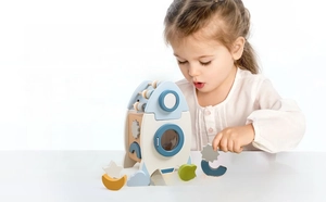Toddler playing with educational rocket shape sorter wooden busy box activity center toy