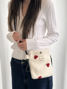 Soft white plush crossbody bag with red 3D heart and woven strap for casual style