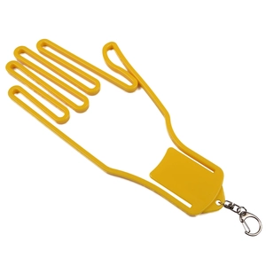 Macro view of yellow hand-shaped golf glove stretcher with metallic clip for hanging