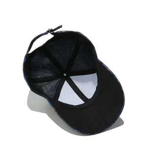 Internal view of navy denim baseball cap with floral pattern and adjustable metal buckle