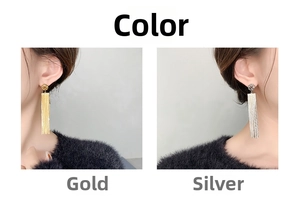 Close-up of long tassel earrings in gold and silver finish on model showing side profile