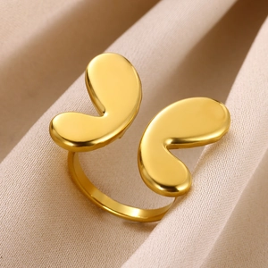 Detailed macro view of 18K gold butterfly open ring on elegant silk fabric texture