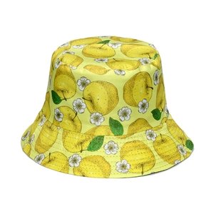Detail of yellow fruit pattern fisherman hat with apples and white flowers