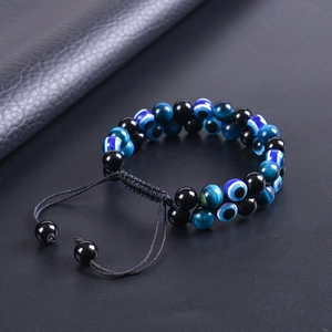 Close-up of double-layer woven evil eye bracelet with tiger eye and black magnetic beads