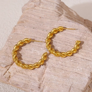 Minimalist gold-plated titanium steel C-shape twisted earrings on natural stone