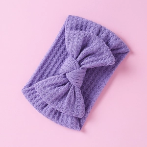 Detail showing purple waffle knit texture and bow knot on soft baby headband