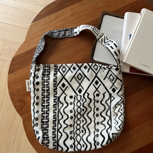Detail of bohemian linen bag with geometric prints and simple wish woven label