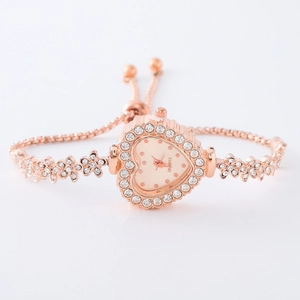 Detail of rose gold heart-shaped watch with crystal-encrusted floral bracelet band