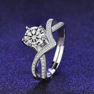 Macro shot of silver six-prong engagement ring with S925 hallmark and pave accents