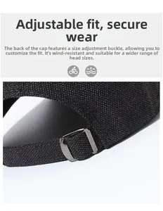 Close-up of adjustable metal buckle and woven strap on a black outdoor baseball cap