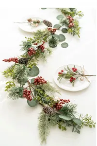 Detail of frosted Christmas garland with red berries, pine cones and snow flocked needles