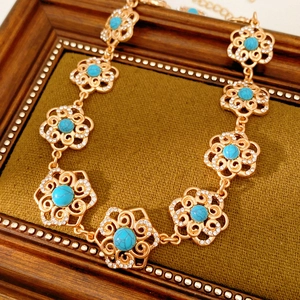 Detail of vintage flower necklace featuring turquoise stones and sparkling rhinestones