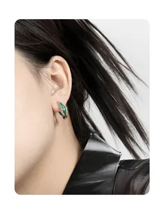 Close-up of S925 sterling silver U-shaped hoop earrings with green marbled enamel on model