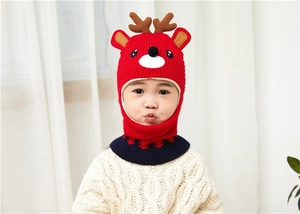 Detail of red Christmas deer knitted hood with navy blue scarf and reindeer antlers