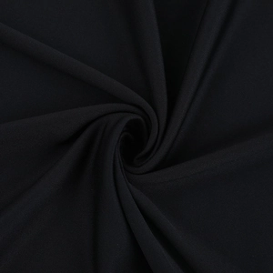 Macro shot of black satin fabric with elegant spiral pleats and fine woven texture