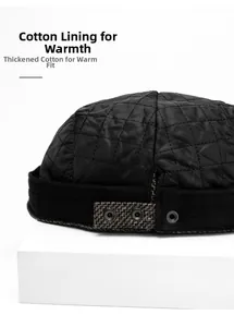 Detail of black quilted newsboy hat with thermal padded lining and adjustable metal buckle