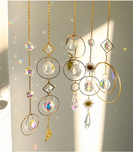 Detail of hanging suncatchers showing crystal spheres reflecting rainbow light patterns