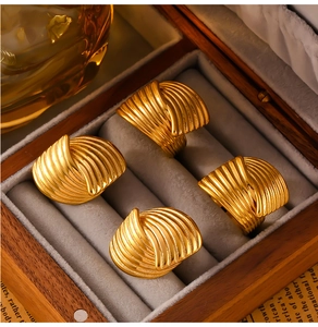 Detailed macro view of four textured 18K gold-plated chunky wrap rings in vintage style