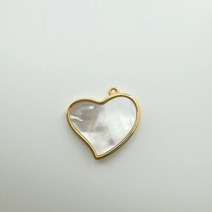 Close-up of 18K gold-plated heart pendant with natural white mother of pearl inlay