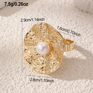 Detailed view of irregular hammered gold ring with pearl inlay and product dimensions