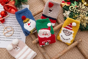 Detailed view of 5 pairs of thick coral fleece Christmas socks on a wooden ladder setup