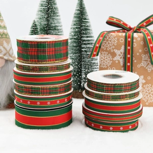 Detail of Christmas ribbons with snowflake prints and plaid patterns on gift boxes