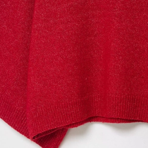 Women's red melange knit sweater featuring a stylish ribbed hem and soft texture