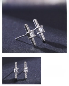 Macro detail of S925 silver stud earrings with square zircon stones and pavé accents