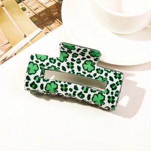 Macro shot of rectangular acetate hair claw with green leopard and shamrock patterns
