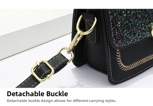 Detail of detachable gold metal buckle and colorful sequins on black crossbody bag