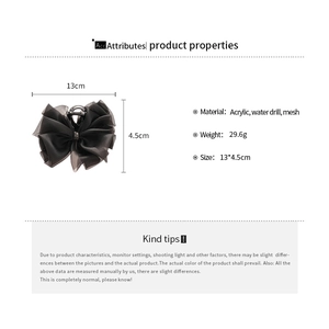 Dettaglio della pinza per capelli con fiocco nero e strass, dimensioni 13cm x 4,5cm