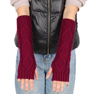 Detailed knit texture of long fingerless gloves in dark red with classic cable patterns