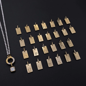 Macro detail of 26 gold stainless steel A-Z initial pendants and rhinestone necklace set