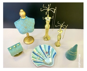 Detailed teal velvet bust and gold geometric necklace stand set for jewelry display