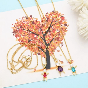 Detailed view of three gold family necklaces with pearls and colorful gemstones