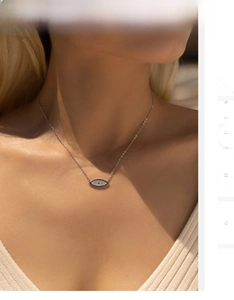 Close-up of S925 silver blue evil eye pendant necklace worn on neck for a boho style look