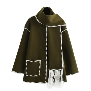 Elegant dark green wool coat with white contrast stitching and matching fringe scarf
