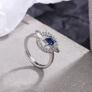 Silver adjustable star ring with deep blue center stone and sparkling orbital circle halo