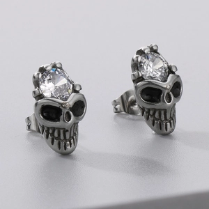 Macro detail of gothic skull stud earrings with sparkling round cubic zirconia stones