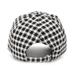 Detail view of black and white plaid baseball cap with silver metal adjustable buckle