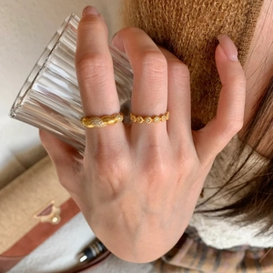 Golden brushed 925 sterling silver rings with micro-pave crystals on female model